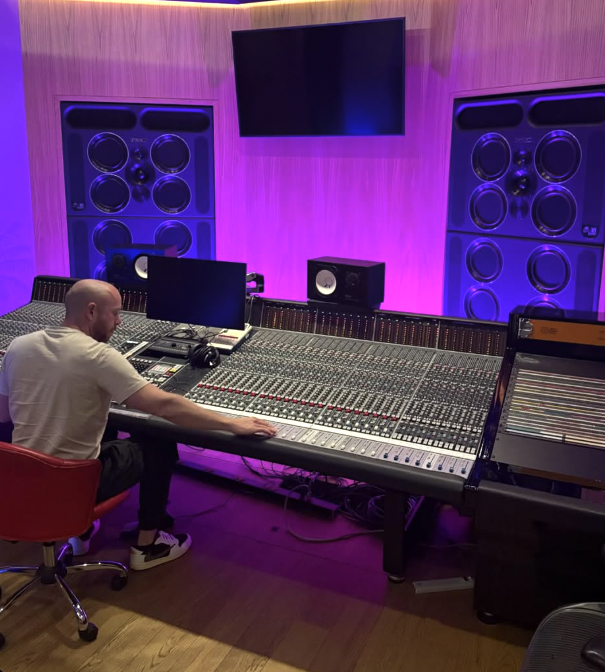 Sean D at a purple-lit mixing console